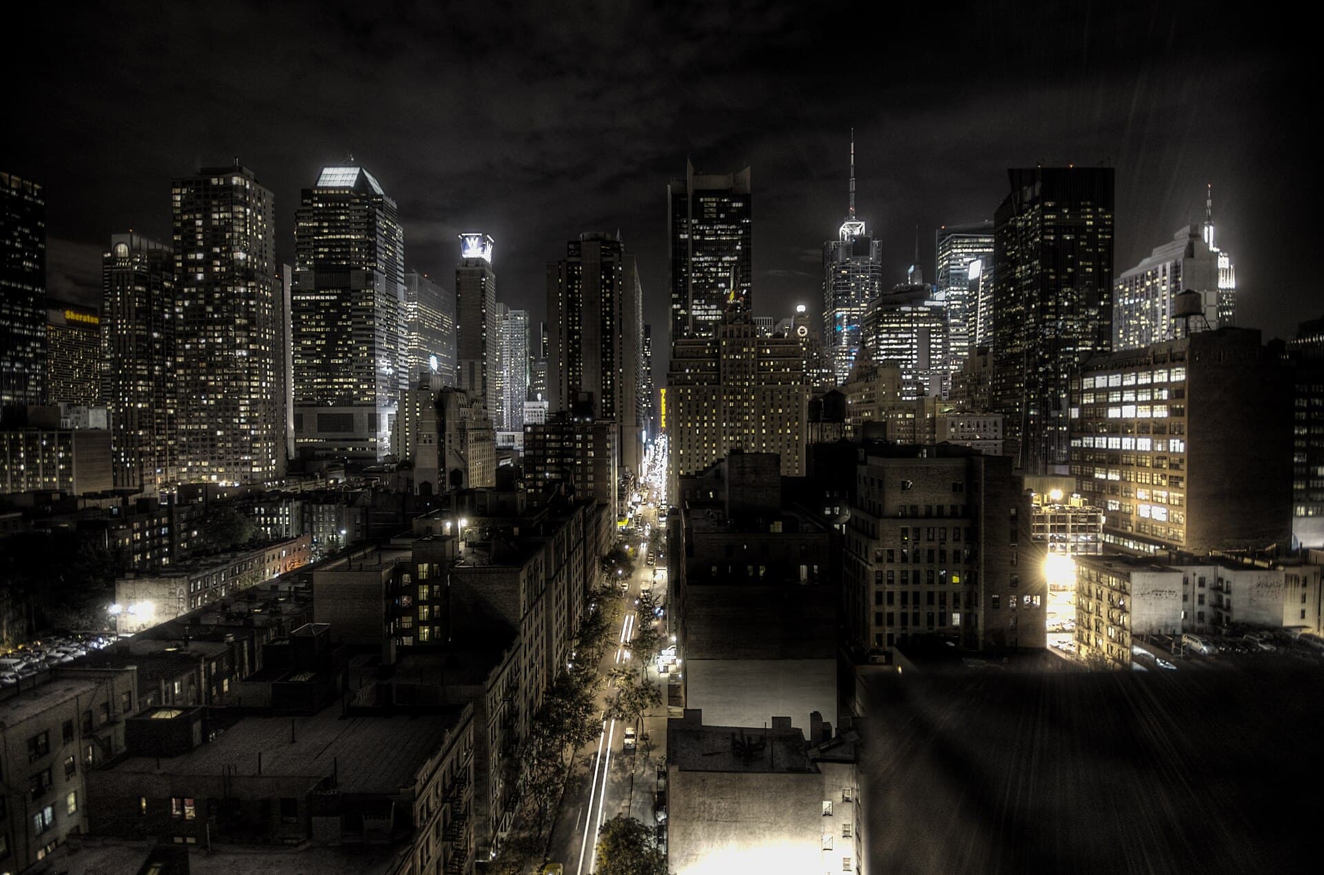 New York City travel planning photo showing New York City at night, photographed using the HDR technique. Looking east along West 45th St. The yellow sign in the center is Milford Plaz