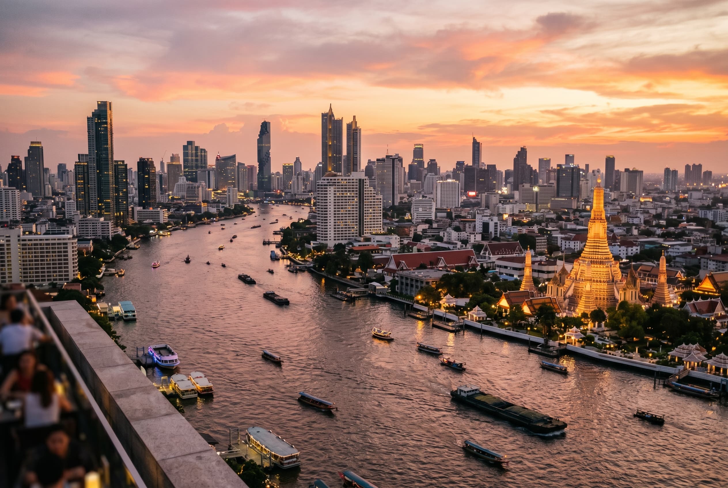 Bangkok skyline above the river with towers glowing in warm evening light
