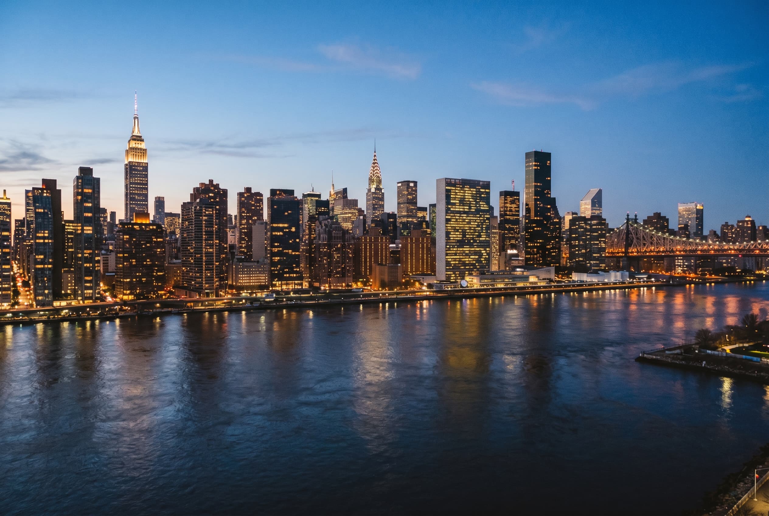 New York City skyline with Midtown towers above the East River at dusk