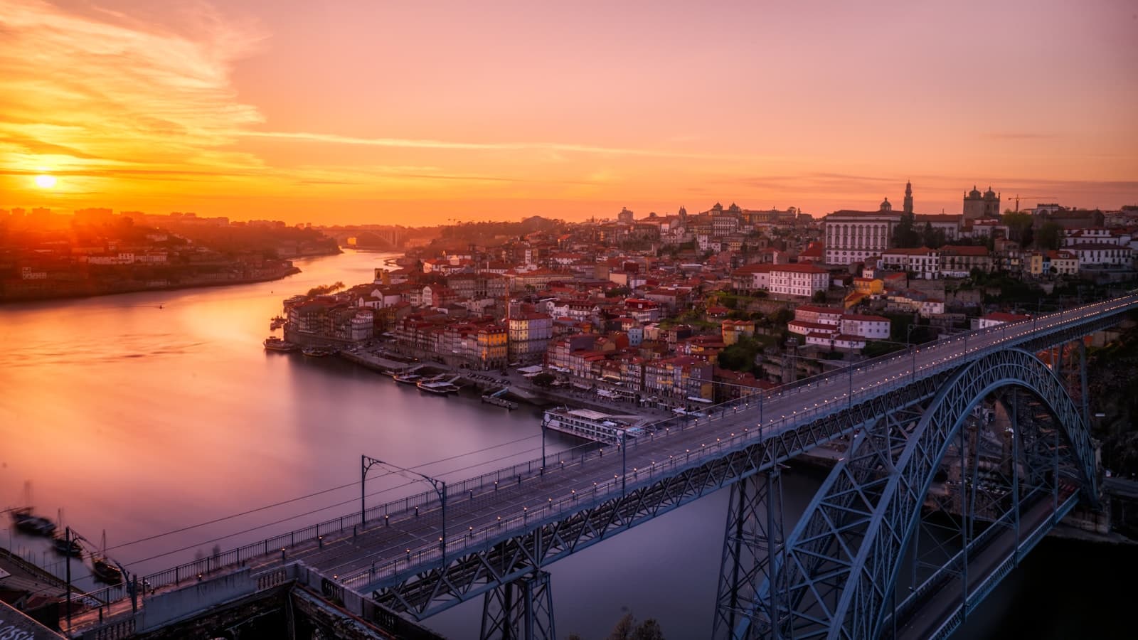 Lisbon hillside with colorful buildings and the Tagus River beyond